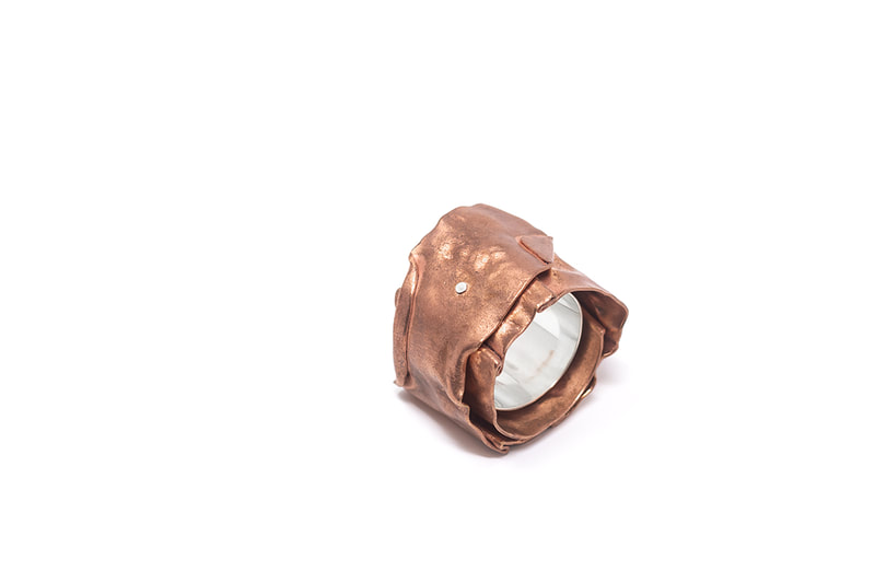 Chunky silver and copper ring in natural copper color on white background